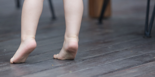 Little toddler doing toe walking